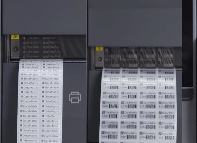 A strip of DataMatrix barcode labels being printed.